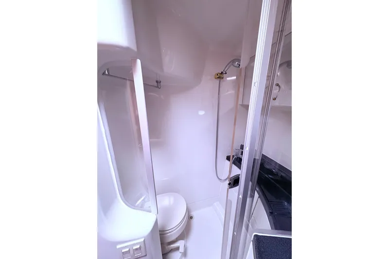 Slide: The Image of Luxurious bedroom interior of 2003 Carver 360 Sport Sedan with cozy bedding and wooden cabinets. - 14