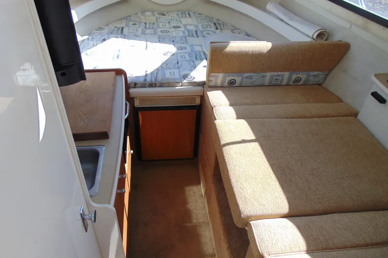 Slide: The Image of 2002 Bayliner 2452 Ciera Classic cabin interior with kitchenette and seating area. - 12