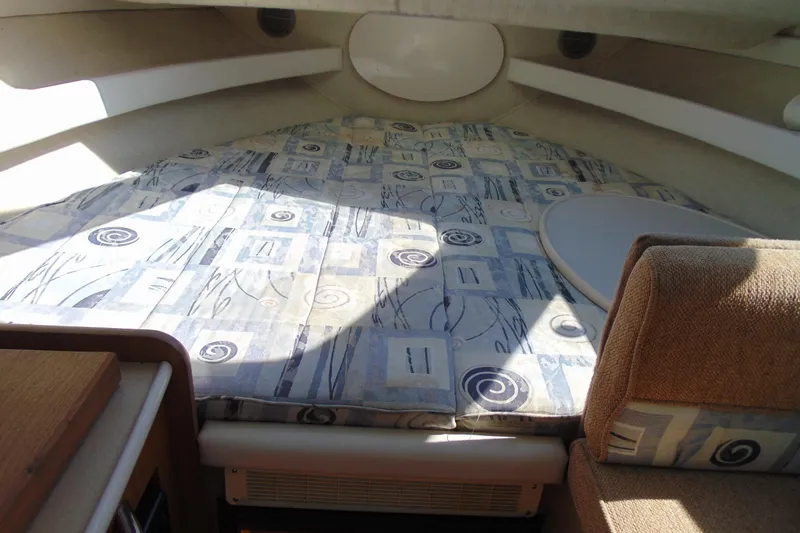 Slide: The Image of Interior cabin of 2002 Bayliner 2452 Ciera Classic with patterned bedding and seating. - 13