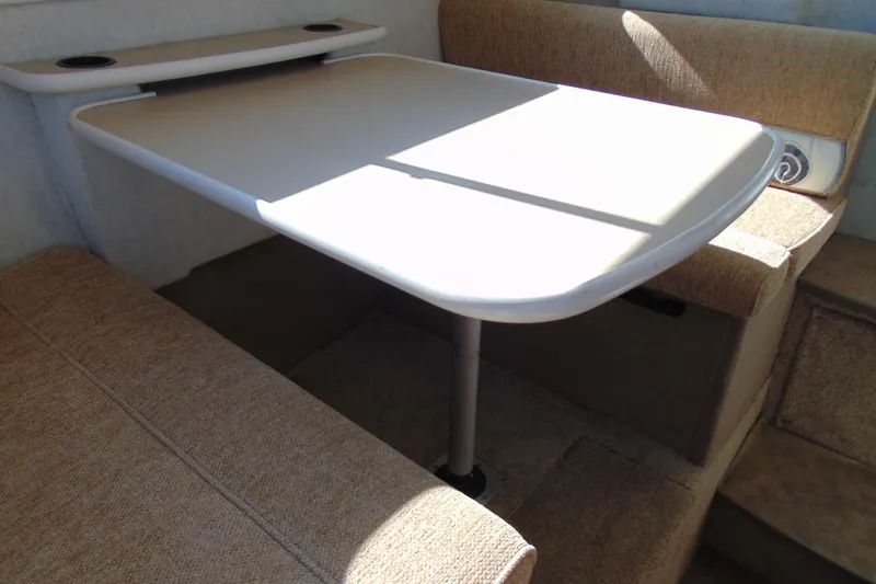 Slide: The Image of Interior dining area of 2002 Bayliner 2452 Ciera Classic boat with table and seating. - 18
