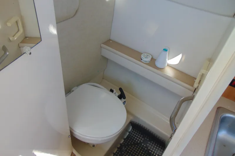 Slide: The Image of 2002 Bayliner 2452 Ciera Classic boat bathroom with toilet and shelf. - 19