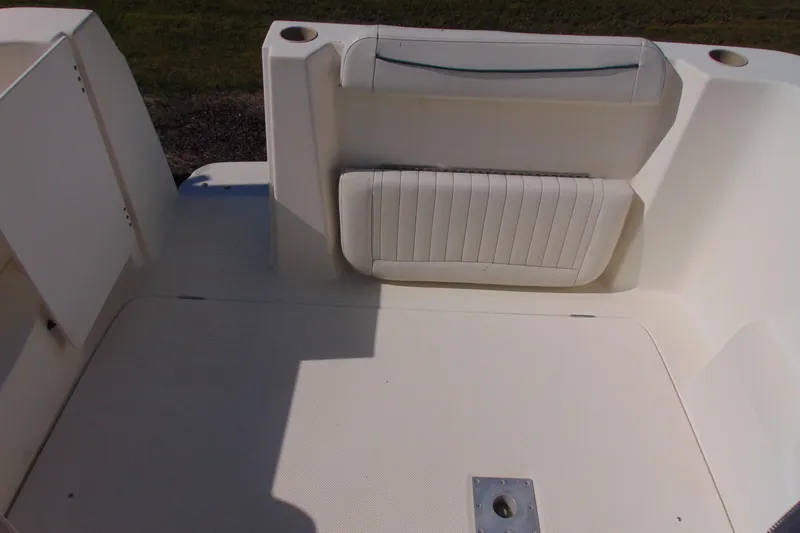 Slide: The Image of 2002 Bayliner 2452 Ciera Classic boat interior with white seating and cup holders. - 5