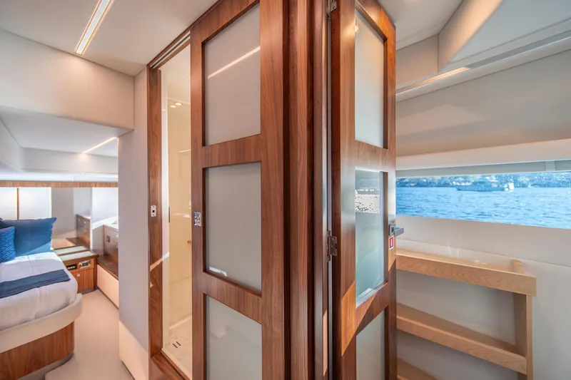 Slide: The Image of Luxurious interior of 2024 Riviera 505 SUV yacht with wood accents and ocean view. - 13