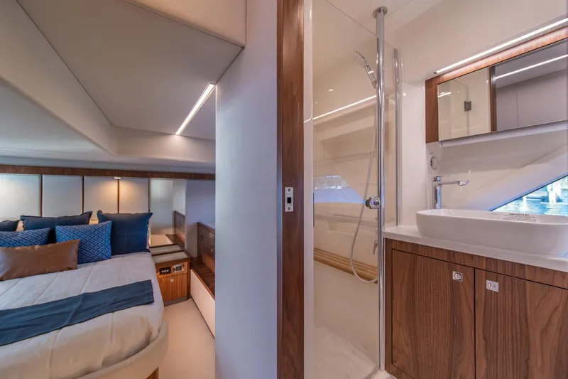Slide: The Image of Luxurious interior of 2024 Riviera 505 SUV yacht featuring bedroom and bathroom. - 18