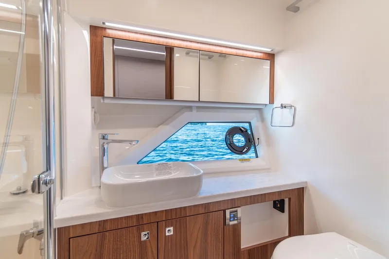 Slide: The Image of Luxurious bathroom interior of 2024 Riviera 505 SUV yacht with ocean view window. - 19