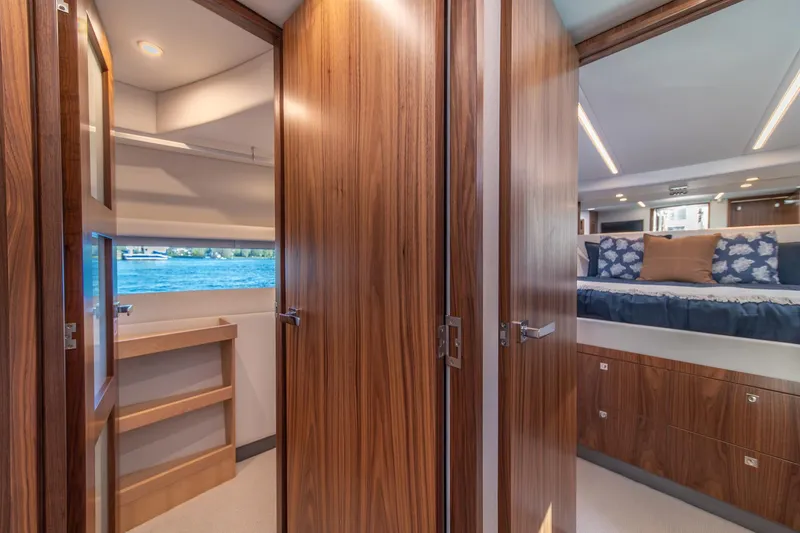 Slide: The Image of Luxurious interior of 2024 Riviera 505 SUV yacht with wood finishes and water view. - 21