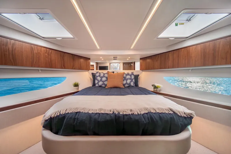 Slide: The Image of Luxurious interior of 2024 Riviera 505 SUV yacht with elegant bedroom and ocean view. - 23