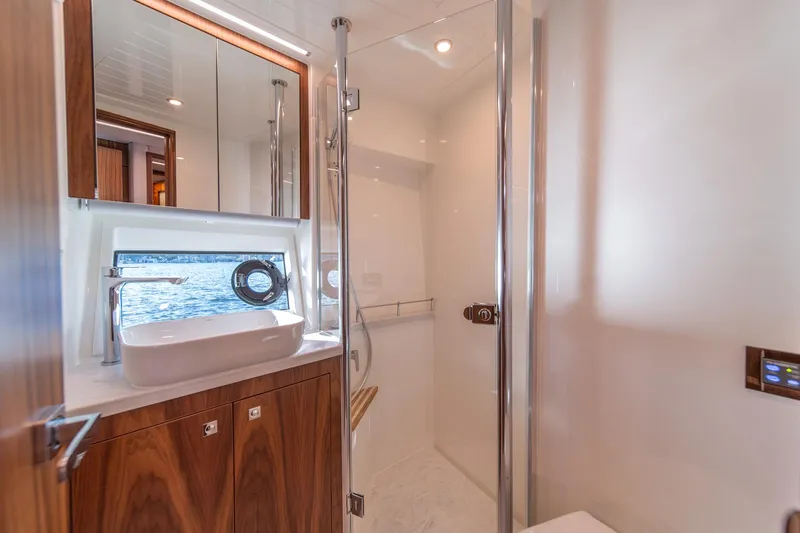 Slide: The Image of Luxurious bathroom interior of 2024 Riviera 505 SUV yacht with modern fixtures and wood accents. - 25