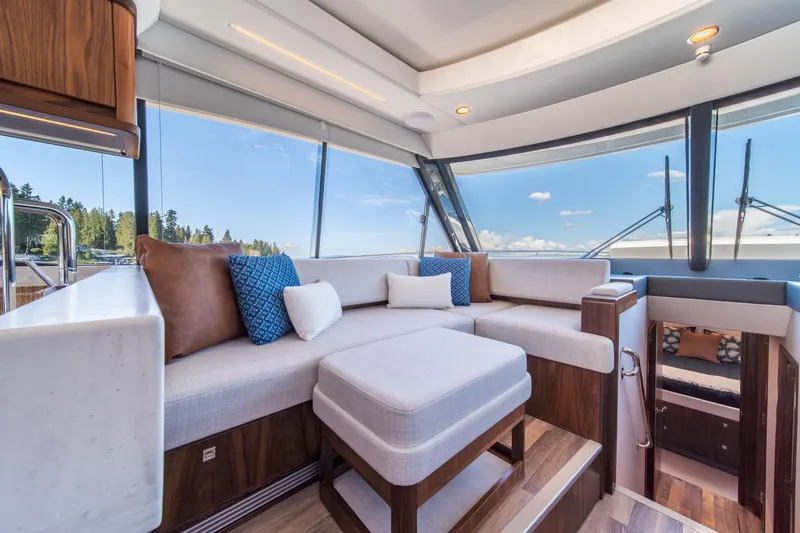 Slide: The Image of Luxurious interior of 2024 Riviera 505 SUV yacht with plush seating and panoramic windows. - 9