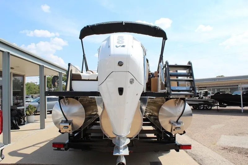 Slide: The Image of 2026 Avalon Catalina Versatile Rear Bench 25 FT pontoon boat, rear view with motor and ladder. - 4