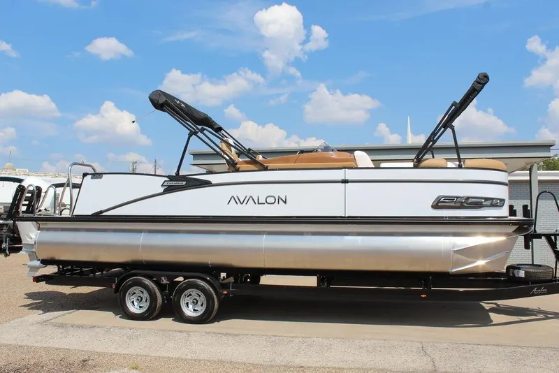 Slide: The Image of 2026 Avalon Catalina Versatile Rear Bench 25 FT pontoon boat on trailer, under blue sky. - 5