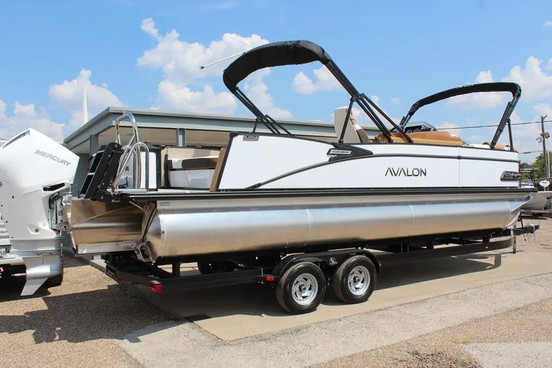Slide: The Image of 2026 Avalon Catalina Versatile Rear Bench 25 FT pontoon boat on trailer, sunny day. - 6