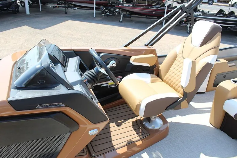 Slide: The Image of 2026 Avalon Catalina Versatile Rear Bench 25 FT boat interior with luxurious captain's chair and dashboard. - 9