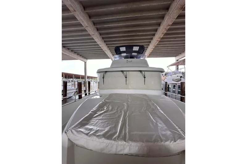 Slide: The Image of 2015 Beneteau Swift Trawler 50 docked under a covered marina. - 17