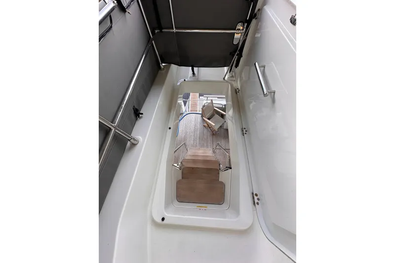 Slide: The Image of 2015 Beneteau Swift Trawler 50 interior stairs and deck view. - 20