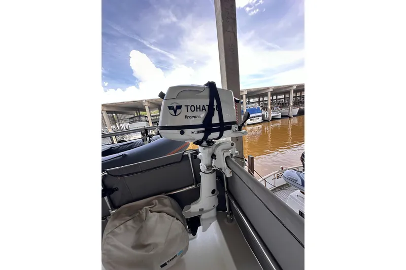 Slide: The Image of Tohatsu outboard motor on 2015 Beneteau Swift Trawler 50, docked at marina. - 32