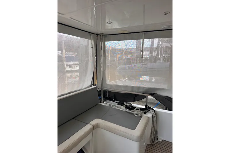 Slide: The Image of Interior view of 2015 Beneteau Swift Trawler 50 with seating and covered windows. - 36