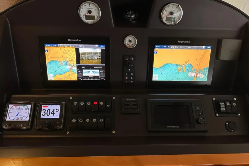 Slide: The Image of Control panel of a 2015 Beneteau Swift Trawler 50 with navigation displays. - 39