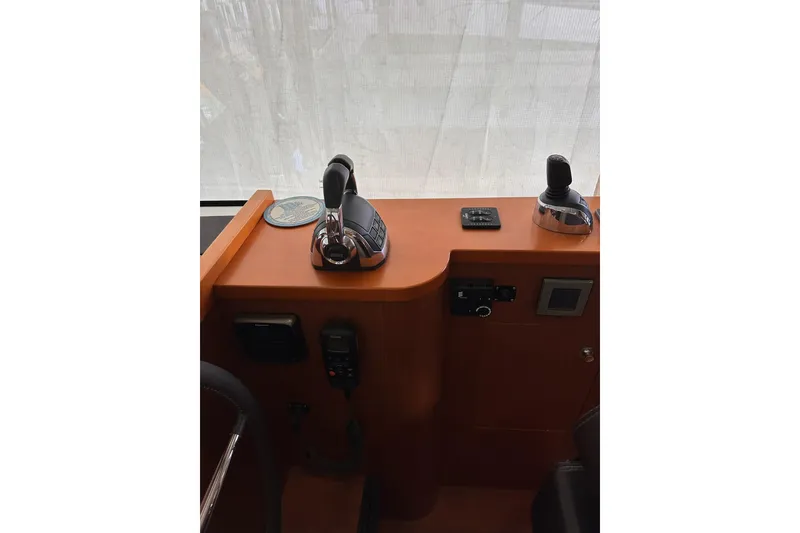 Slide: The Image of Control panel of 2015 Beneteau Swift Trawler 50 with throttle and joystick. - 41