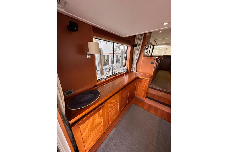 Slide: The Image of Interior of 2015 Beneteau Swift Trawler 50 with wood finish and window view. - 49