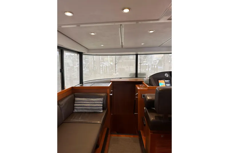 Slide: The Image of Interior of 2015 Beneteau Swift Trawler 50 with modern seating and navigation area. - 50