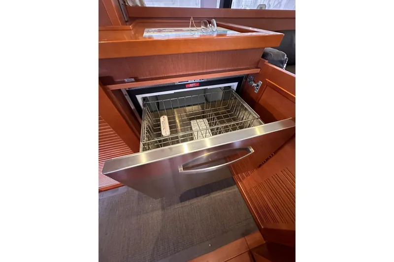 Slide: The Image of Open dishwasher drawer in 2015 Beneteau Swift Trawler 50 yacht kitchen. - 53