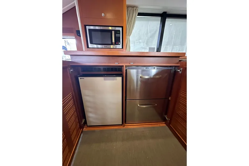 Slide: The Image of Galley of 2015 Beneteau Swift Trawler 50 with microwave, fridge, and dishwasher. - 58