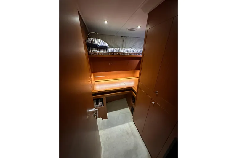 Slide: The Image of 2015 Beneteau Swift Trawler 50 cabin interior with bunk bed and wooden cabinetry. - 70