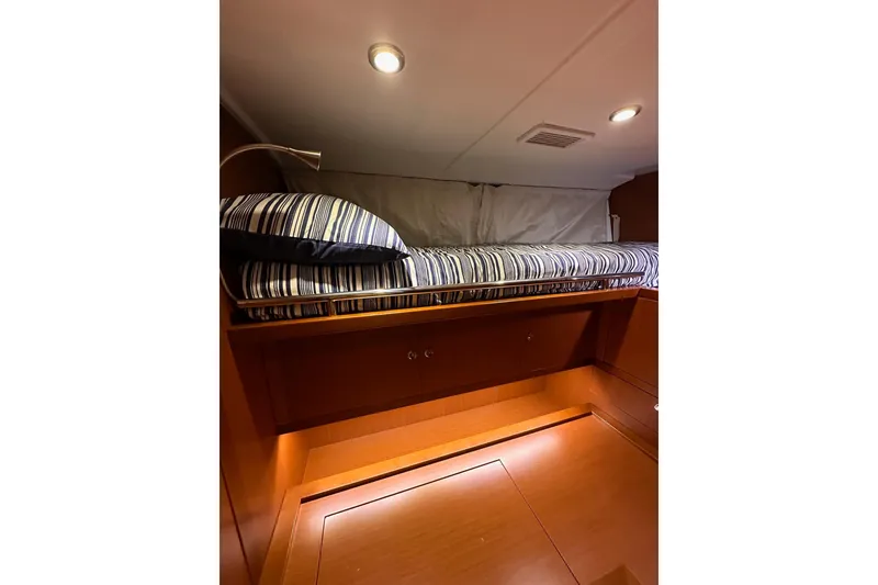 Slide: The Image of Cozy cabin interior of 2015 Beneteau Swift Trawler 50 with striped bedding. - 71