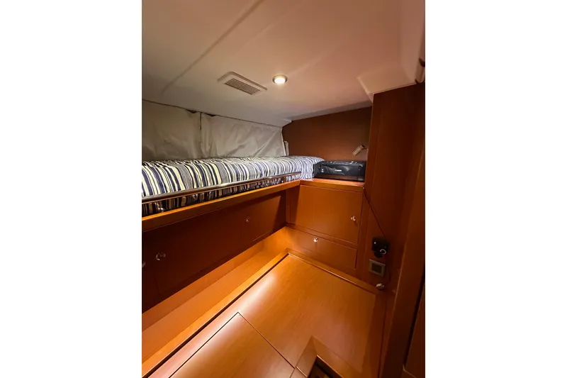 Slide: The Image of Cozy cabin interior of 2015 Beneteau Swift Trawler 50 with striped bedding. - 74