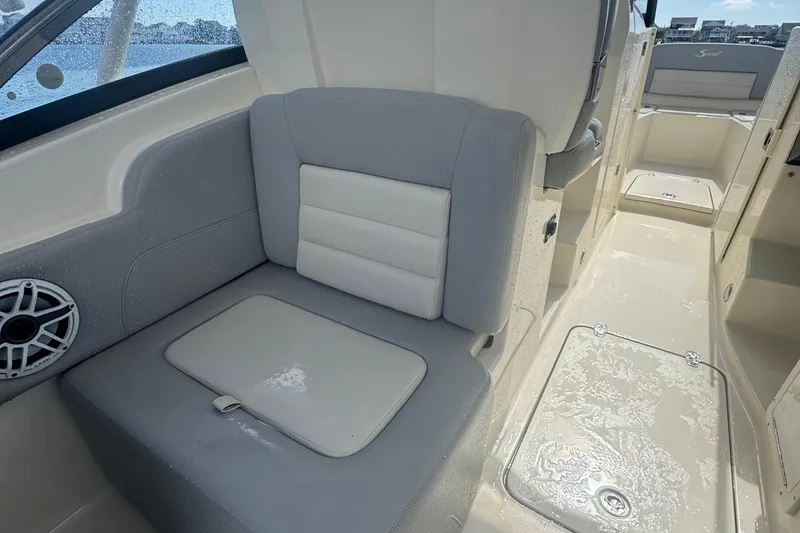 Slide: The Image of 2020 Scout 255 Dorado boat interior with cushioned seating and speaker. - 12