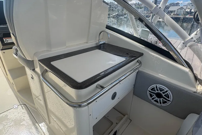 Slide: The Image of 2020 Scout 255 Dorado boat interior with sink and cutting board. - 13