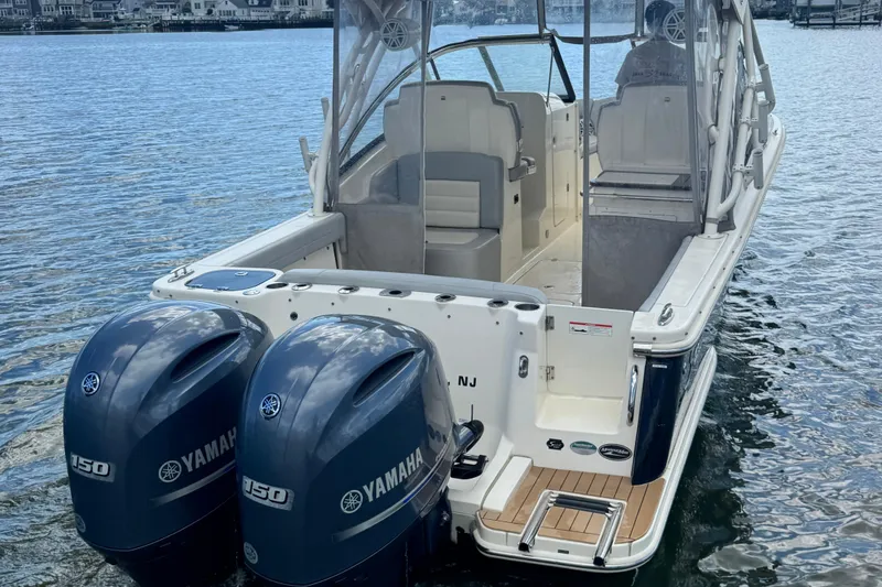 Slide: The Image of 2020 Scout 255 Dorado boat with twin Yamaha 150 engines on water. - 3