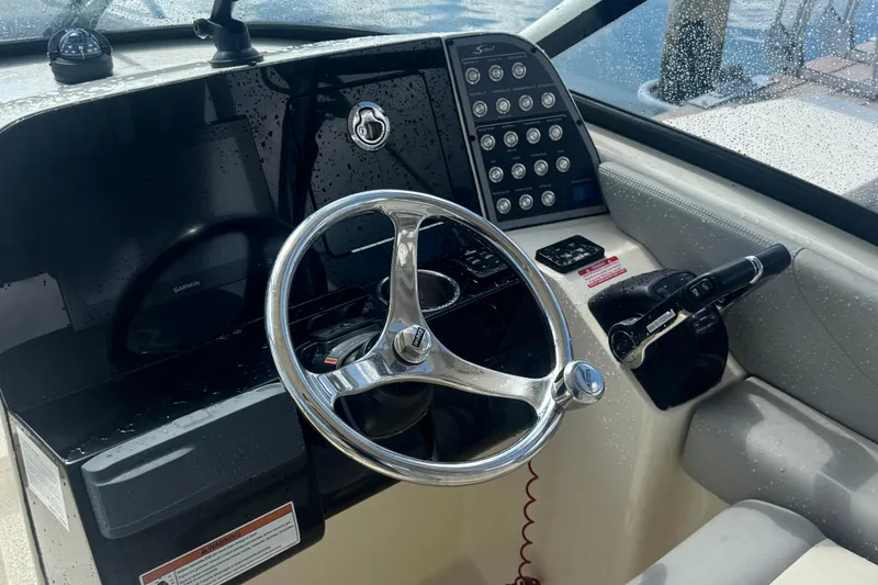 Slide: The Image of 2020 Scout 255 Dorado boat helm with steering wheel and control panel. - 4