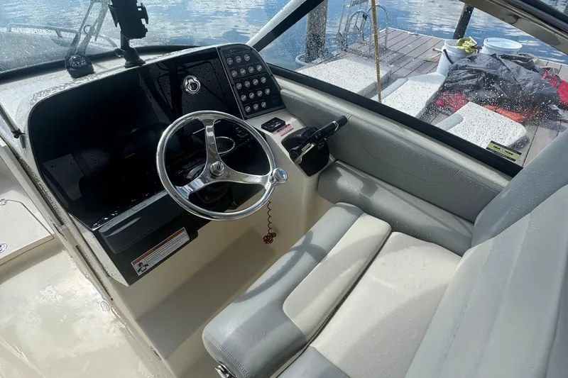 Slide: The Image of 2020 Scout 255 Dorado boat cockpit with steering wheel and control panel. - 5