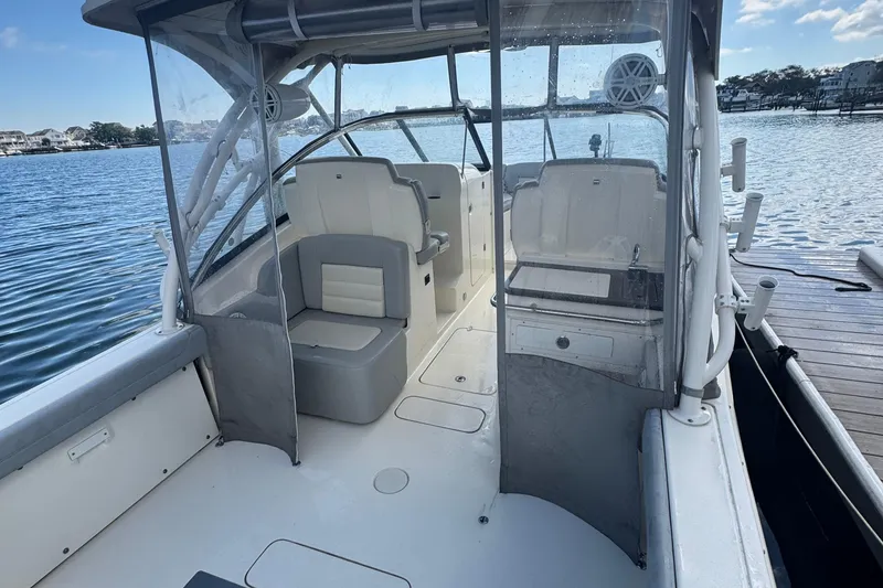 Slide: The Image of 2020 Scout 255 Dorado boat interior with seating, docked by the water. - 6