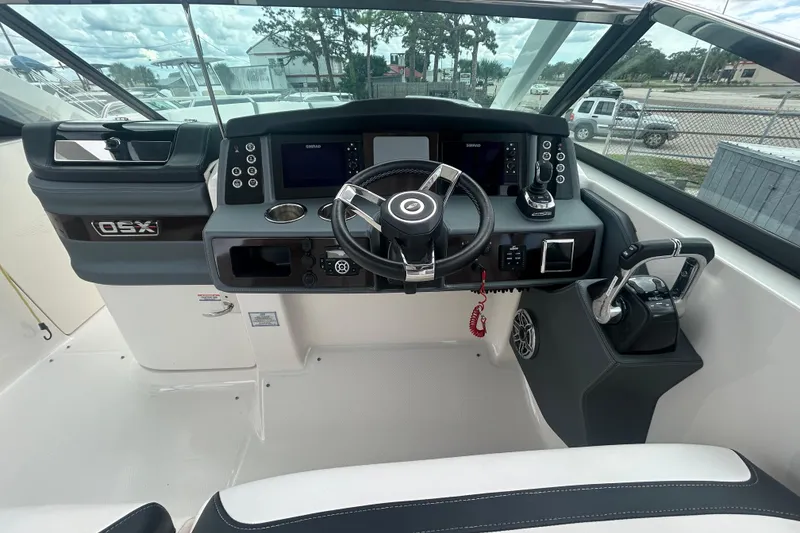 Slide: The Image of 2021 Chaparral 280 OSX boat helm with modern controls and steering wheel. - 11