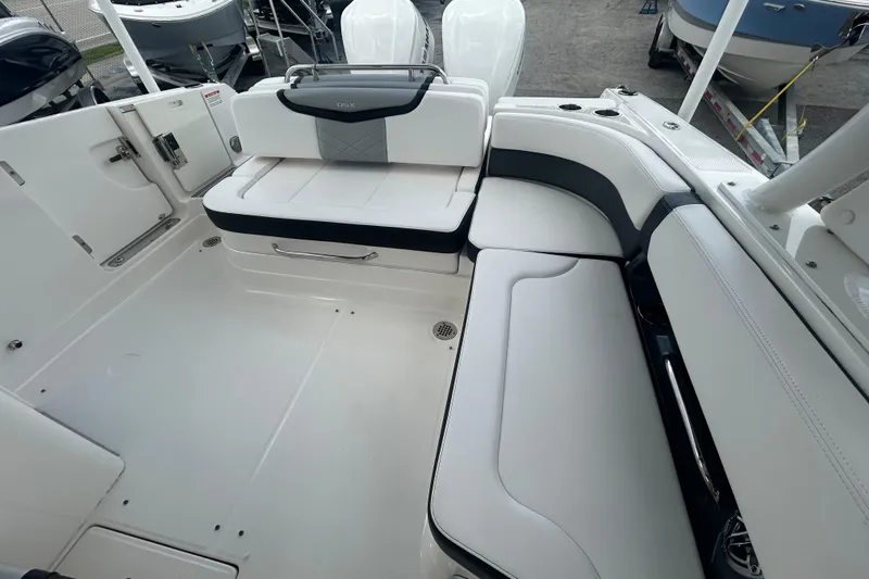 Slide: The Image of 2021 Chaparral 280 OSX boat interior with white seating and sleek design. - 13