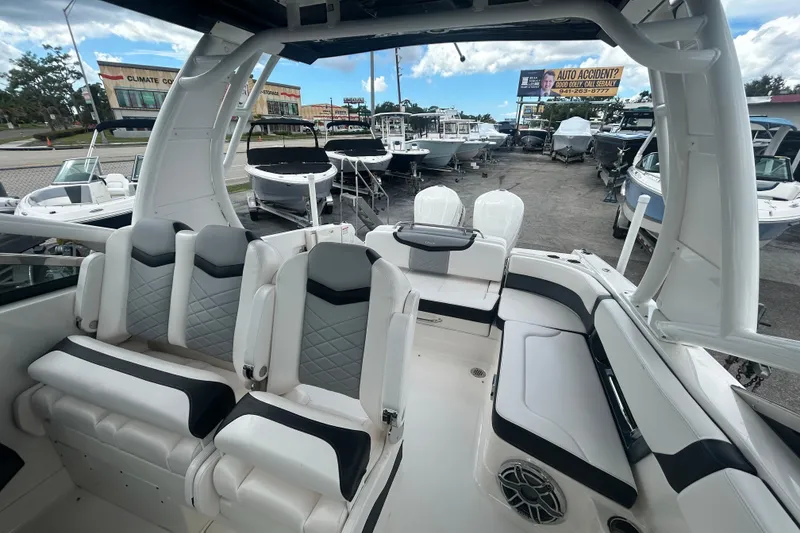 Slide: The Image of 2021 Chaparral 280 OSX boat interior with modern seating and sleek design. - 15
