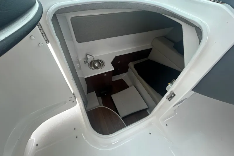 Slide: The Image of Interior cabin of 2021 Chaparral 280 OSX boat with sink and seating area. - 19