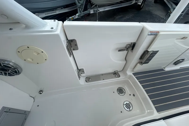 Slide: The Image of 2021 Chaparral 280 OSX boat interior, featuring sleek white design and stainless steel fixtures. - 22