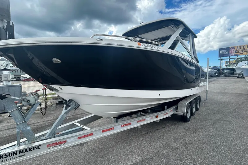 Slide: The Image of 2021 Chaparral 280 OSX boat on trailer under cloudy sky. - 4