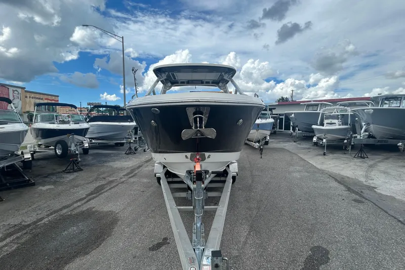 Slide: The Image of Chaparral 280 OSX 2021 boat on trailer under cloudy sky at dealership. - 5