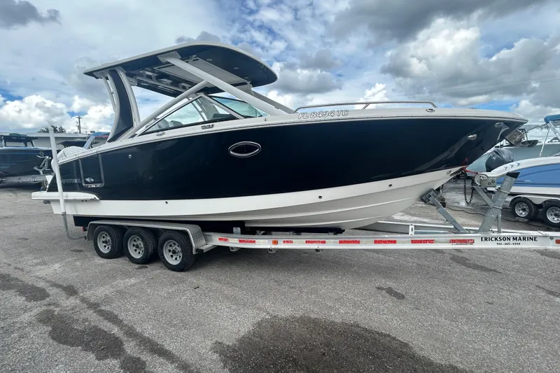 Slide: The Image of 2021 Chaparral 280 OSX boat on a trailer under cloudy skies. - 6