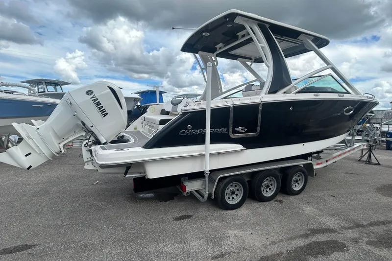 Slide: The Image of 2021 Chaparral 280 OSX boat with Yamaha engine on a trailer, under cloudy sky. - 7