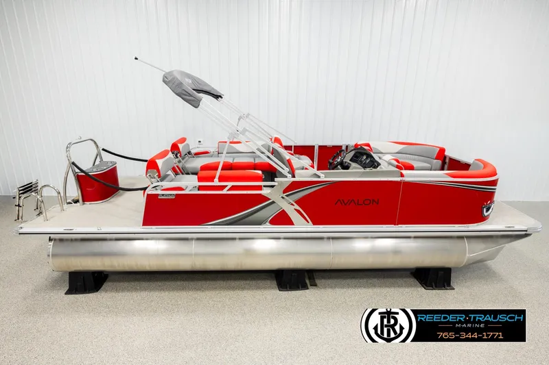 The Image of 2026 Avalon LSZ QLS pontoon boat, red and silver design, displayed indoors. - 1