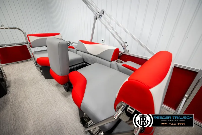 Slide: The Image of 2026 Avalon LSZ QLS boat interior with red and gray seating, Reeder-Trausch Marine logo. - 23