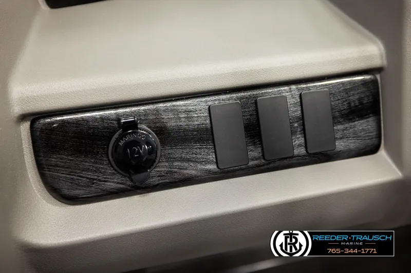 Slide: The Image of 12V power outlet and switches on 2026 Avalon LSZ QLS boat dashboard. - 37