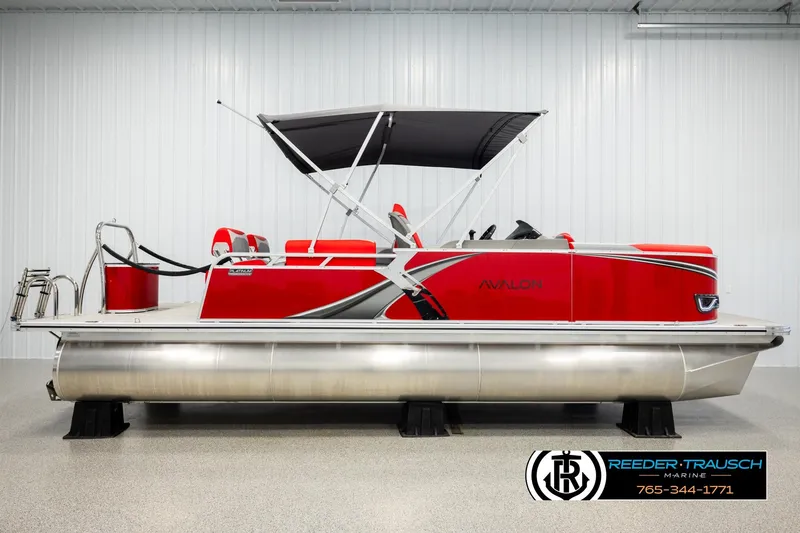 Slide: The Image of 2026 Avalon LSZ QLS pontoon boat, red with black canopy, displayed indoors. - 5