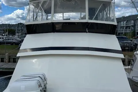 Slide: The Image of 1989 Viking 41 Convertible yacht docked at marina under cloudy sky. - 6